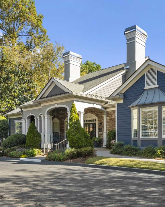 the front of a house with a driveway and a blue house