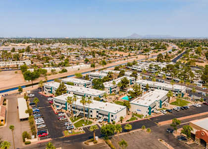 A large commercial area with a parking lot and several buildings.at Gilbert Square Apartments, Mesa, AZ 85203