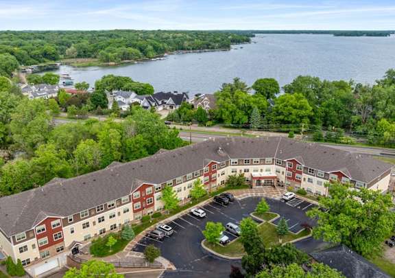 A large building with a parking lot in front of it.