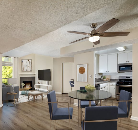 a living room and dining room with a table and chairs