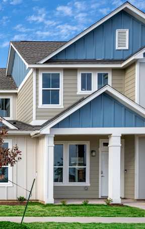 a row of houses with blue and white roofs at Mihir Taylor, Taylor