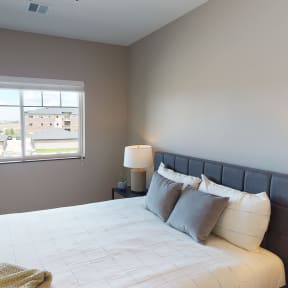 a bedroom with a large bed and a window