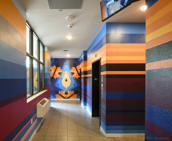 a hallway with a colorful mural on the side of a building