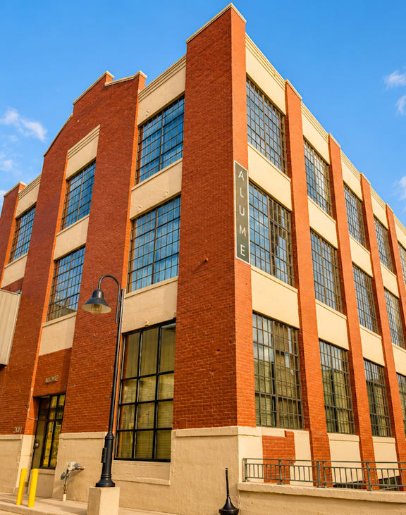A red brick building with a clear blue sky in the background.