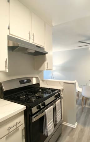 a kitchen with a stove and a ceiling fan at The Hills Apartments at Thousand Oaks, Thousand Oaks, CA 91360