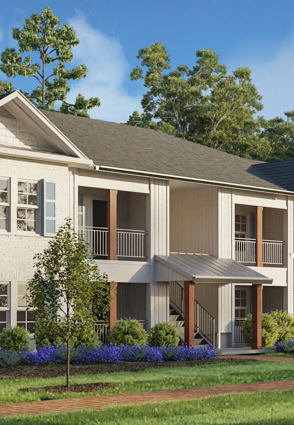 a rendering of an apartment building with a lawn and trees