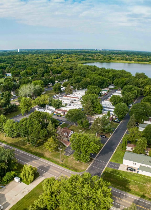 an aerial view of a trailer park next to a body of water