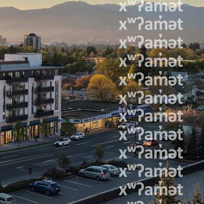 A modern building with a parking lot in front of it.