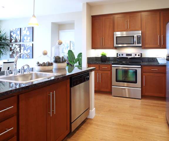 a kitchen with stainless steel appliances and wooden cabinets