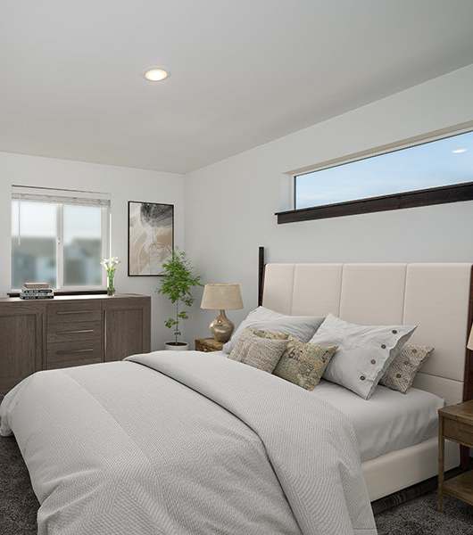 A bedroom with a large bed and a mirror on the wall.