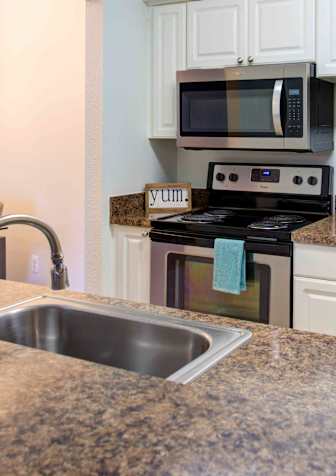 Kitchen with stove at Pine Ridge Apartments, Rochester Hills