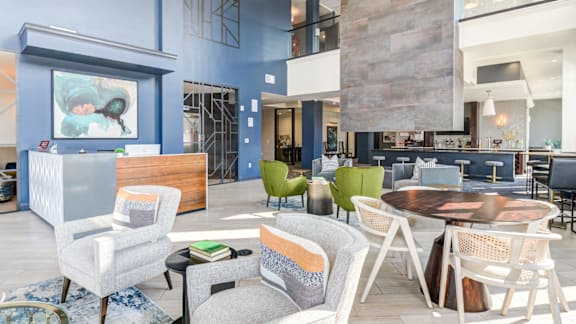 A modern living room with a blue accent wall and a variety of seating options.