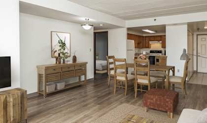 A living room with a white couch and wooden furniture.