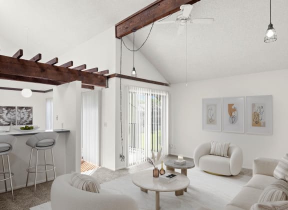 a living room with white walls and a ceiling with exposed beams
