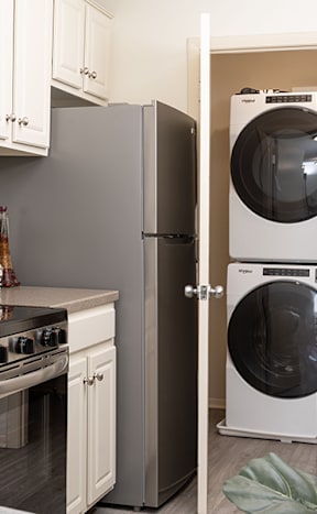 a kitchen with a washer and dryer and a refrigerator