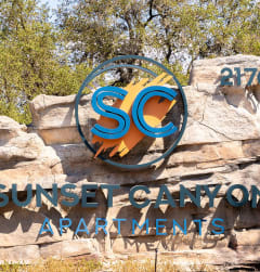 a sign for the sunset canyon archway at the entrance to the zoo
