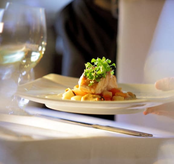 a plate of food on a table at a restaurant at Alexandria of Carmel Apartments, Carmel, 46032