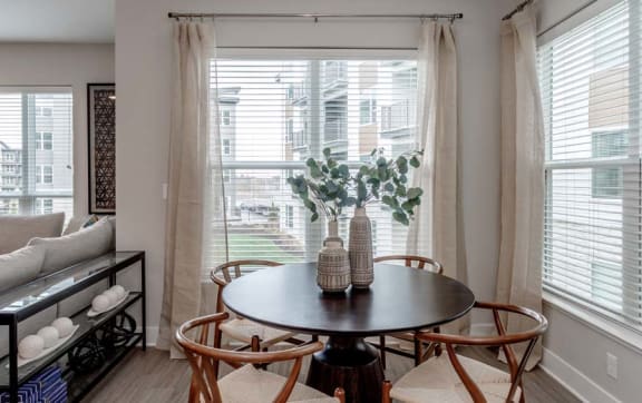a living room with a table and a couch and a window
