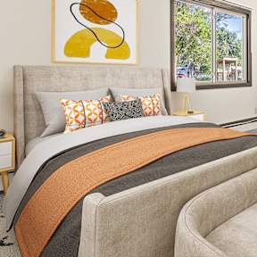 a bedroom with a bed and a chair