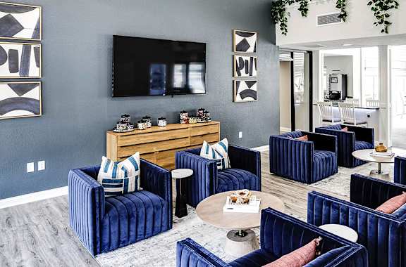 a living room with blue furniture and a tv