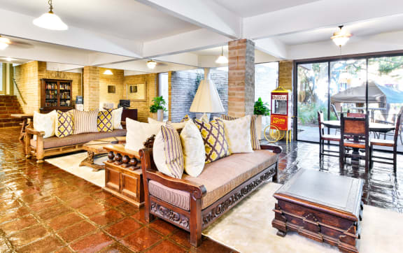the lobby of a hotel with a large marble floor and benches  at Mediterranean Village West Hollywood, West Hollywood