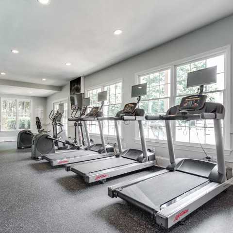 A spacious home gym with treadmills and exercise bikes.