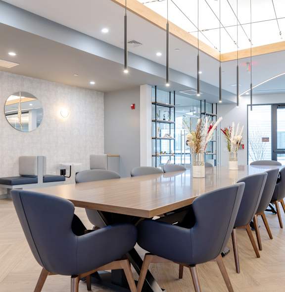 A conference room with a long table and chairs. at Seacoast Residences Apartments, Oakland, ME, 03904
