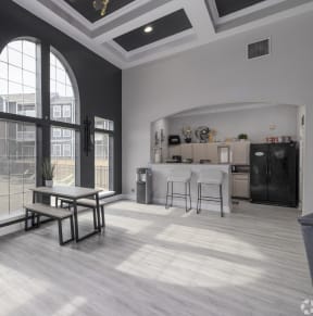 Clubhouse area with fridge, bar stools, counter and window with shades