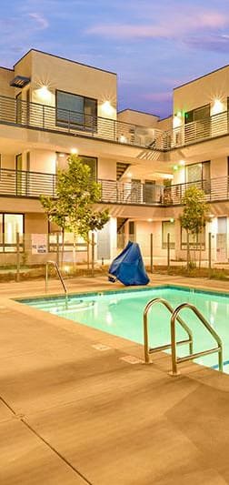 Pool with chairs and views of balconies