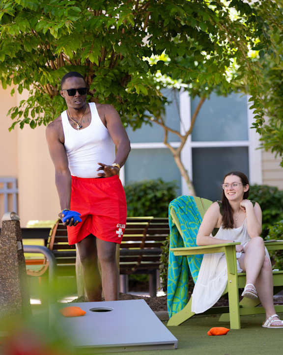a man kneeling down next to a dog at Proximity at ODU, Norfolk, Virginia