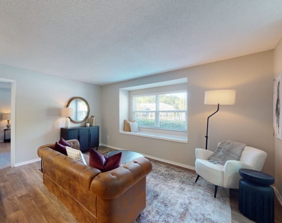 a living room with a couch and a chair and a window at Arbor Ridge, Greensboro
