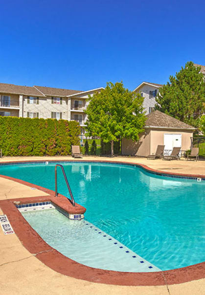 a swimming pool with an apartment building in the background at SILVER CREEK, Washington