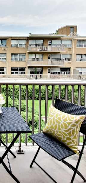 a living room with a couch and a table on a balcony