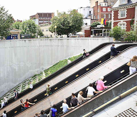people on the escalators at the subway station