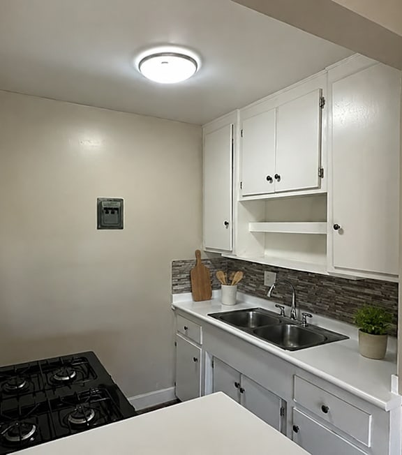 A well-lit, modern kitchen and living room with a dining area.