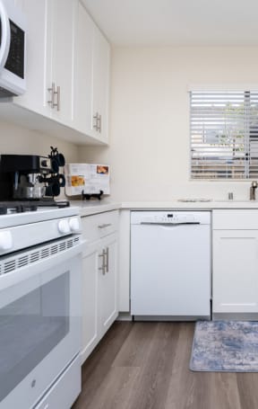 kitchen with white appliances and hardwood flooring at Sunstone Place, Riverside, CA, 92505