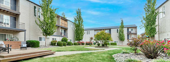 A sunny day at a residential area with apartment buildings and green lawns.