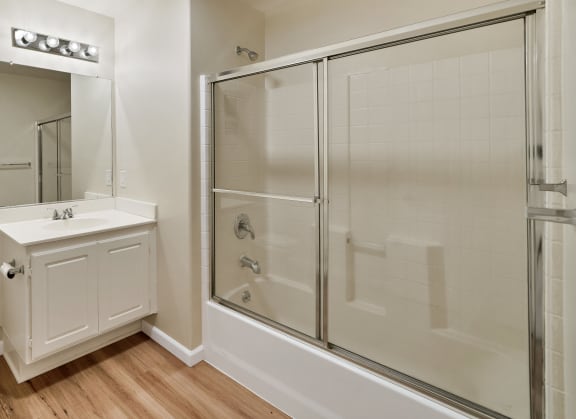 an empty bathroom with a shower toilet and sink