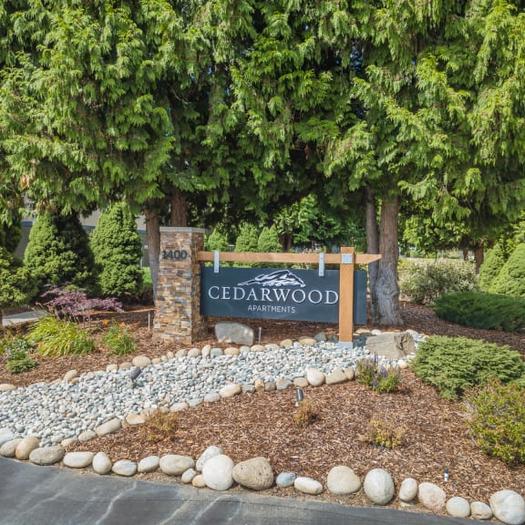 cedarwood apartments front sign with rock landscaping