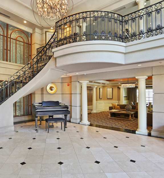 a grand piano sits in the center of the lobby