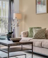 a sofa with white cushions in a living room