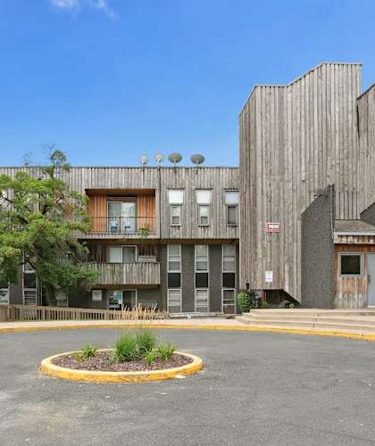 an empty parking lot in front of an apartment building
