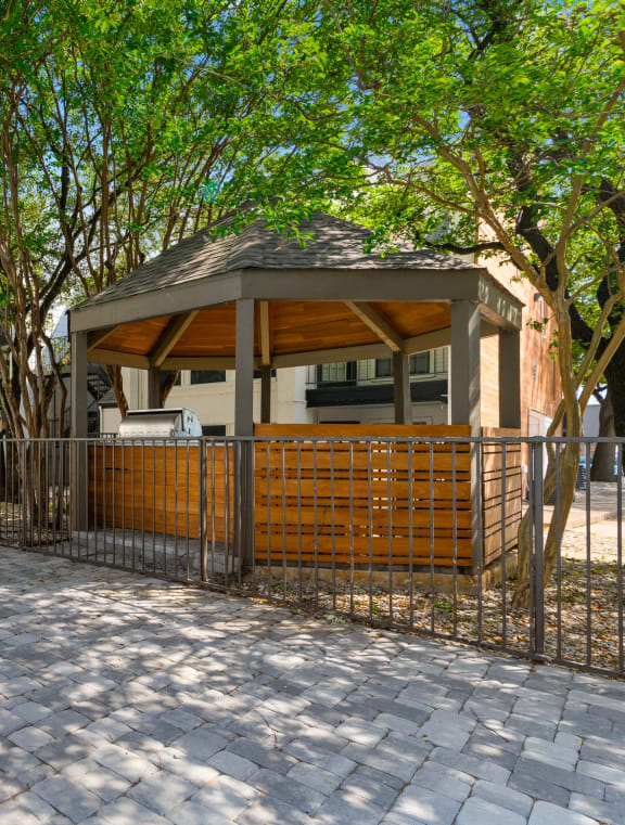 a courtyard with a playground and yellow chairs in front of an apartment building