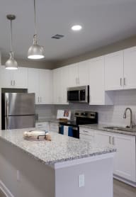 a kitchen with granite counter tops and stainless steel appliances