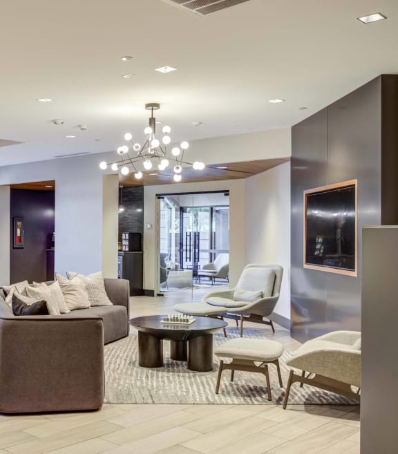 a living room with a couch and a kitchen with a table and chairs