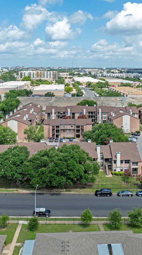 A view of a residential area with houses and cars.