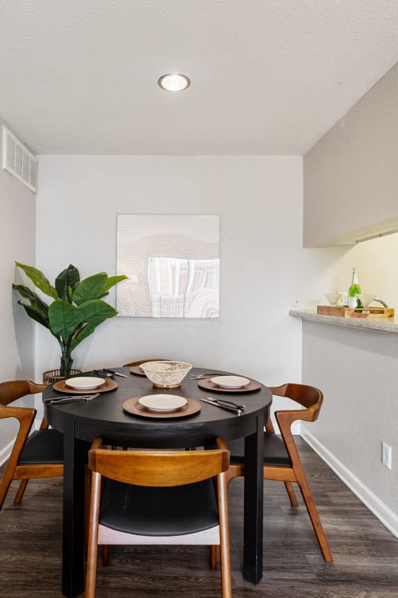 a kitchen with wooden cabinets and a black microwave