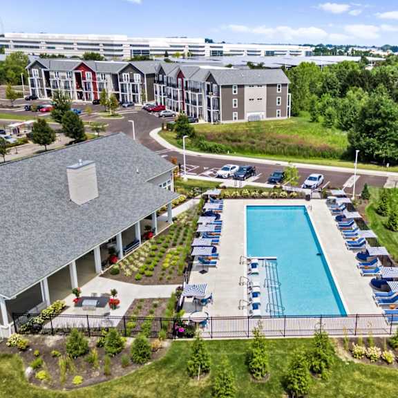 A large building with a pool in front of it.