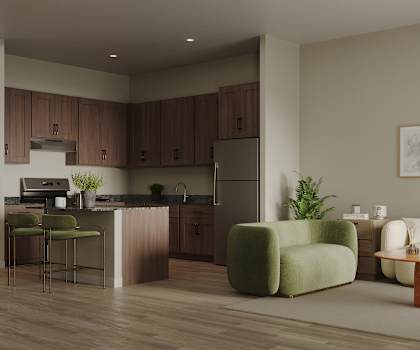 A modern kitchen with a green chair and a white sofa.
