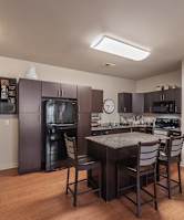 A kitchen with a table and chairs in the middle of the room.